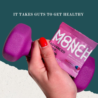 A woman's hand holding a Monch Monch packet and a hand weight